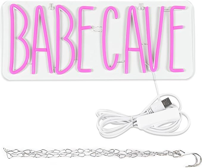 a neon sign that says babe cave with a power cord attached to it and a charger plugged in