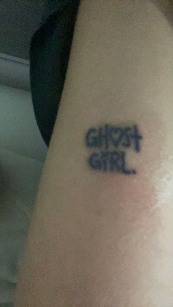 a person with a tattoo that says ghost girl on their left arm and the word ghost girl written in blue ink