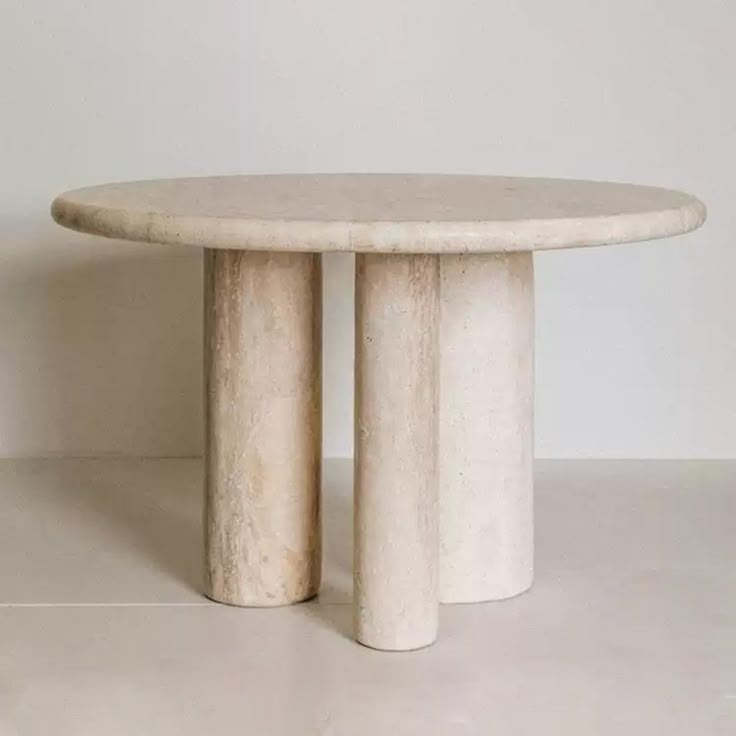 a white marble table sitting on top of a floor