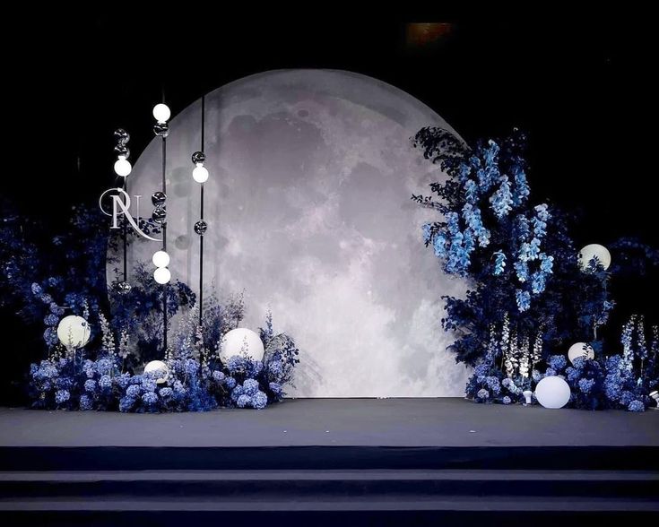 the stage is decorated with blue and white flowers