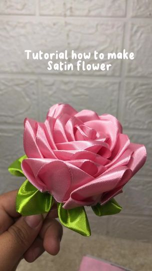 someone is holding a pink rose in their hand with the words, how to make satin flower