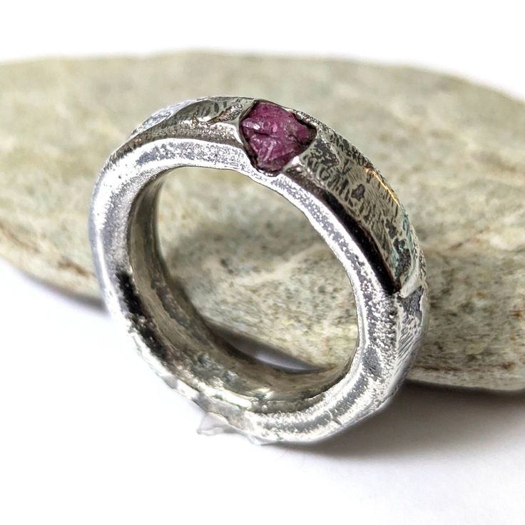 Raw ruby ring sandcast in sterling silver.  Size AU/UK N 1/2, US 7.25 Gorgeous solid silver domed band with organic texture left by the sand and flow of the molten silver. Treat yourself or gift to someone special. This ring makes a perfect engagement or anniversary gift. These rings are very durable making them great for everyday wear.  Unisex design. These rings are cast in sand as one solid piece with melted fine silver and sterling silver. The casting is made from an original design carved i Rubin Ring, Unique Wedding Band, Raw Ruby, Textured Ring, Unique Wedding Bands, Ruby Ring, Natural Texture, Unique Wedding, Fine Silver