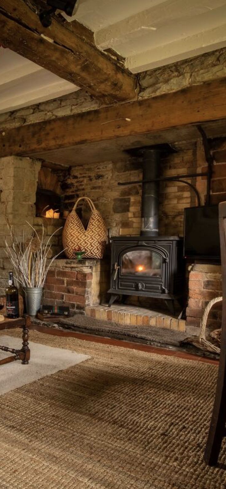 a living room filled with furniture and a fire place in the middle of it's fireplace