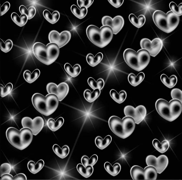 many hearts are arranged in the shape of heart shapes on a black background with sparkles