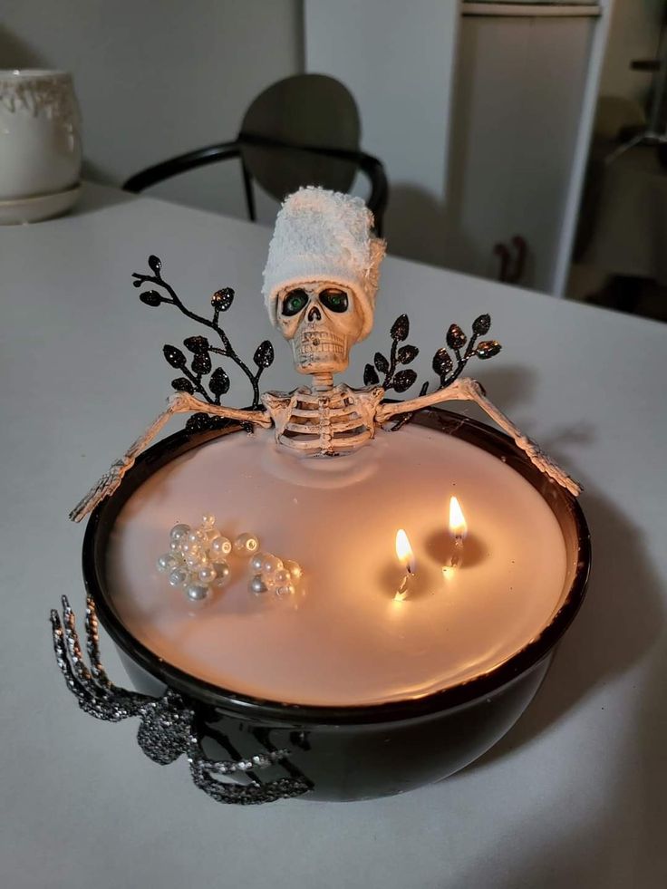 a skeleton sitting on top of a tray with candles