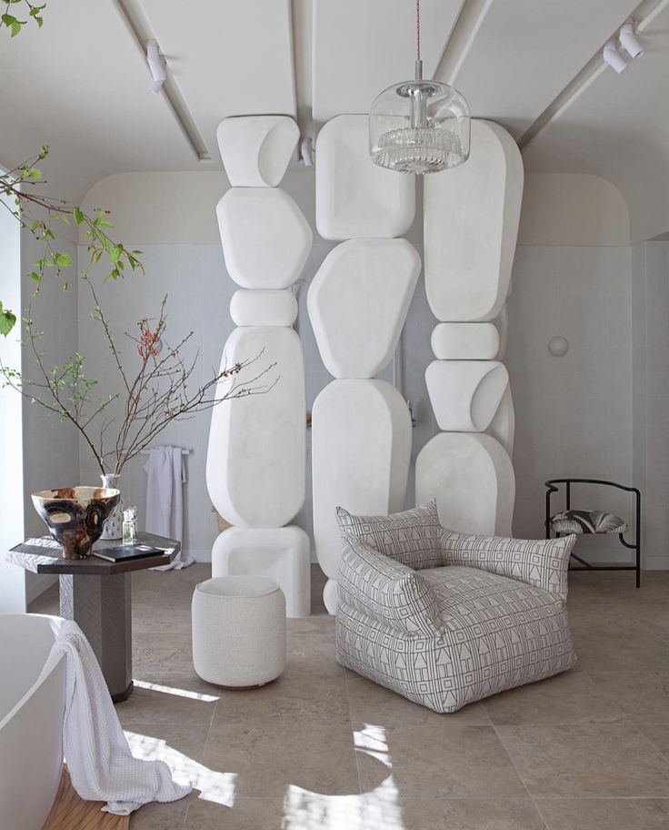 a living room filled with lots of white furniture