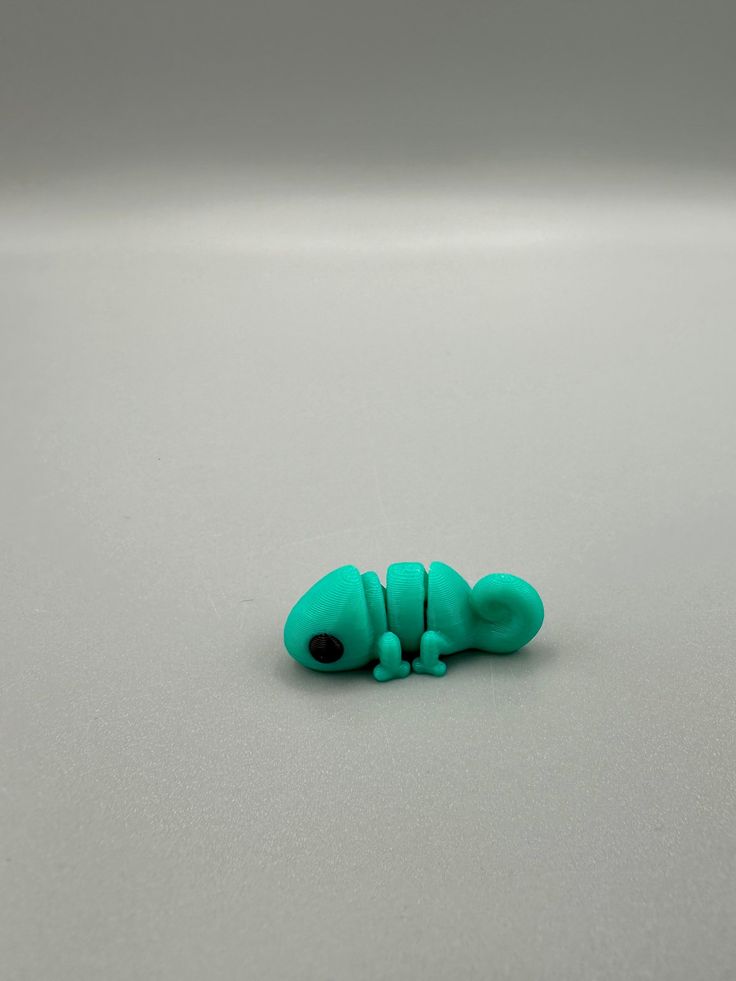 a small green toy sitting on top of a table