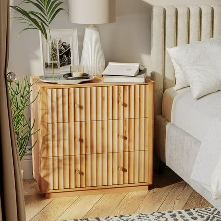 a bed room with a neatly made bed and a wooden dresser next to a window