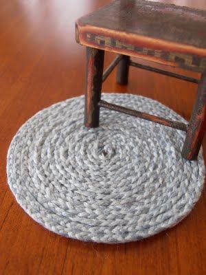 a small chair sitting on top of a wooden floor next to a rug that looks like an old rocking chair