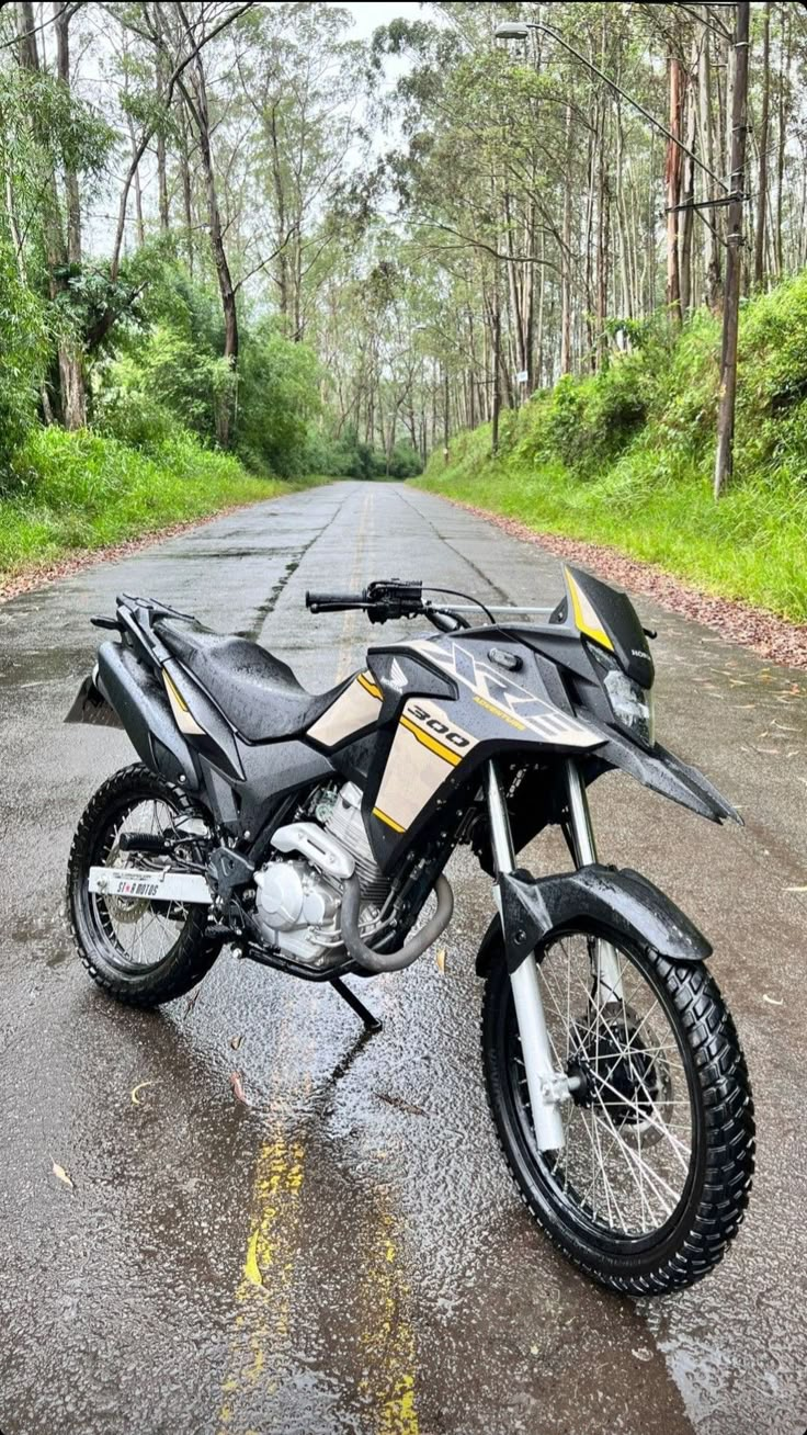 a motorcycle parked on the side of a wet road