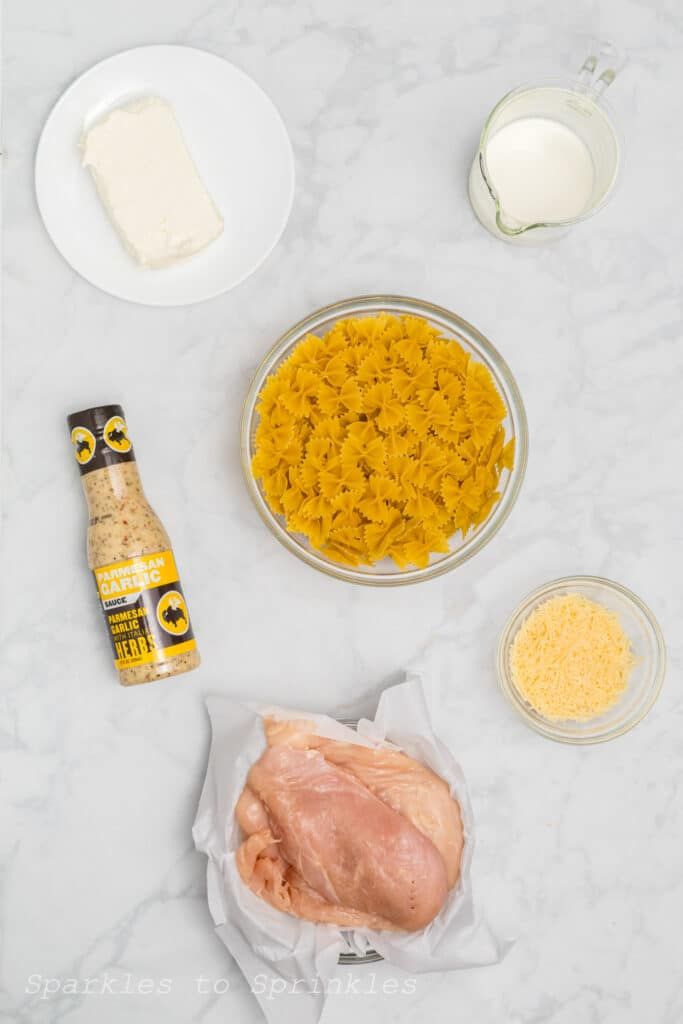 ingredients to make chicken and rice casserole laid out on a white counter top