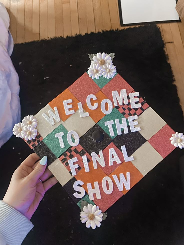 someone is holding up a graduation cap that says welcome to the final show