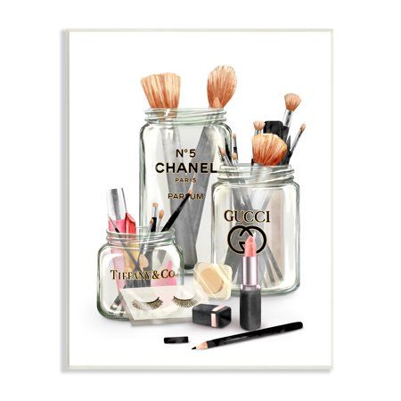 the chanel makeup collection is displayed in glass jars with brushes and eyeliners