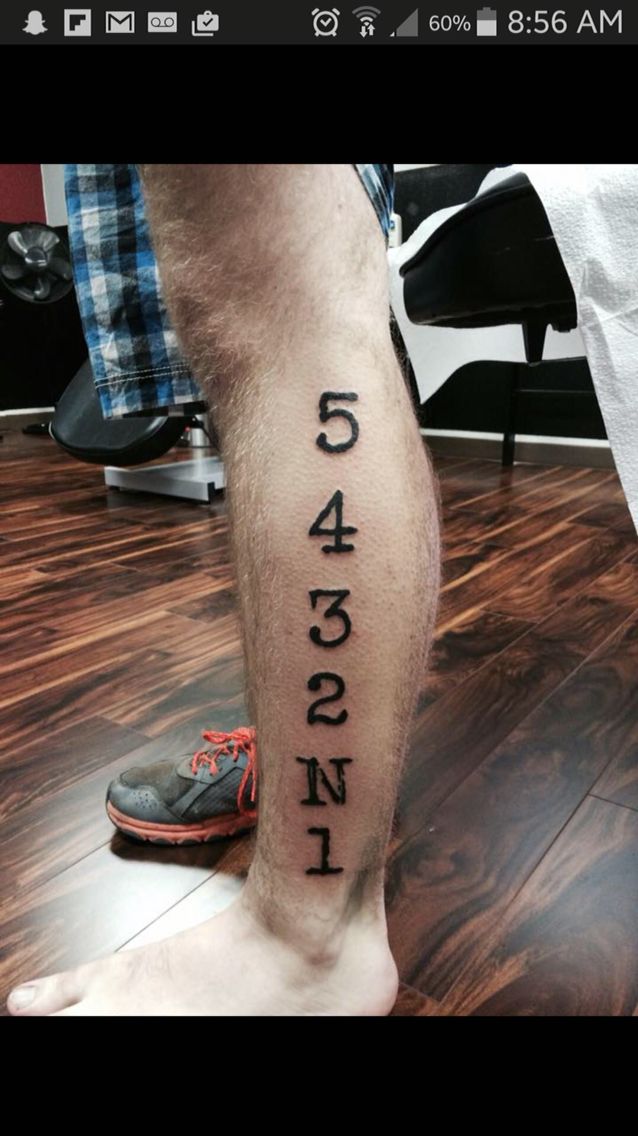 a man's leg with numbers on it, and the words in black ink