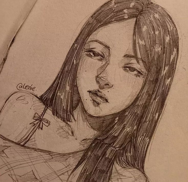 a pencil drawing of a girl with long hair and a cross on her shoulder, looking to the side