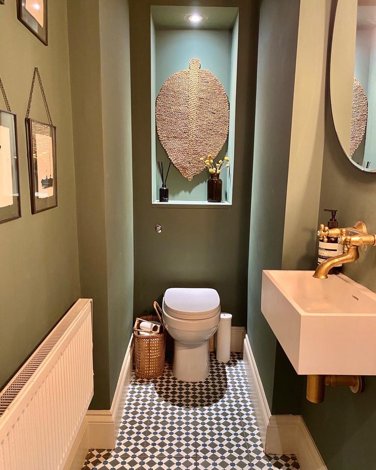 a bathroom with a toilet, sink and mirror on the wall next to a radiator