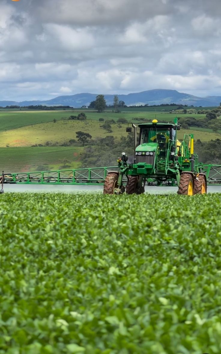 a tractor is driving through a large field