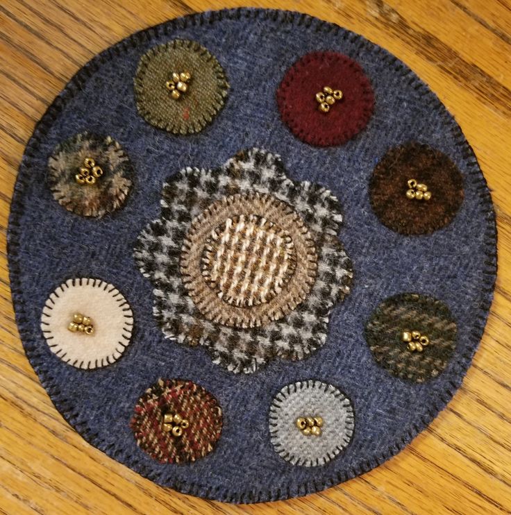 there is a circular patch with many different buttons on the top and bottom of it