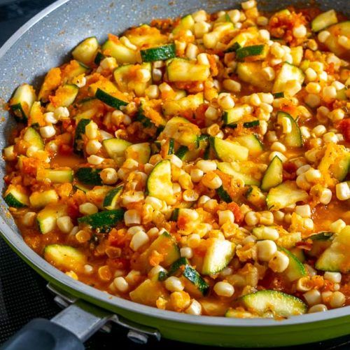 corn and zucchini in a skillet on the stove