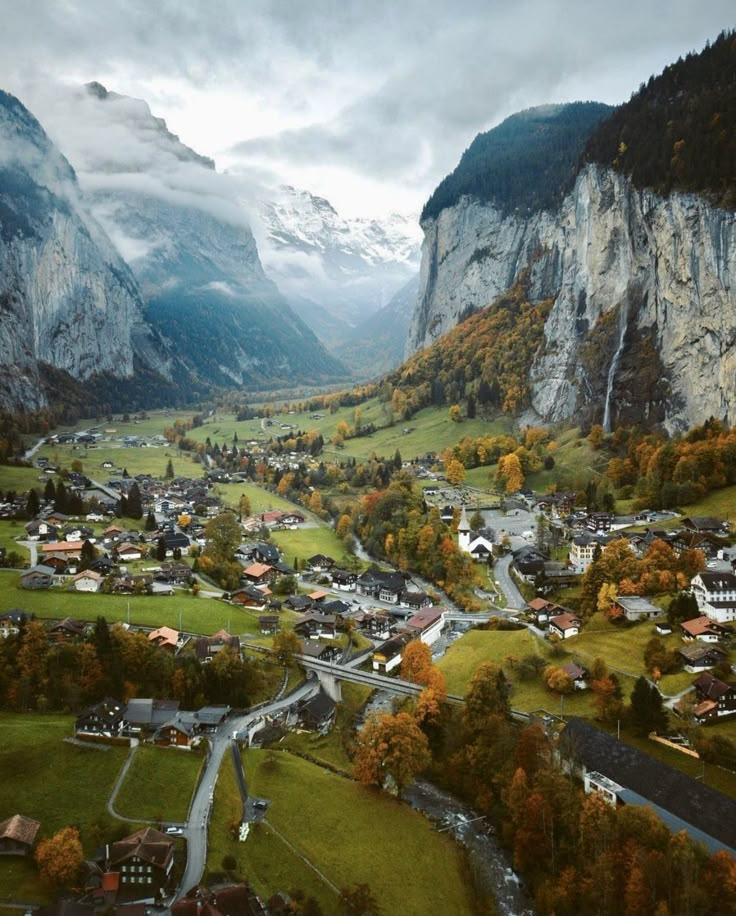 an aerial view of a small town surrounded by mountains