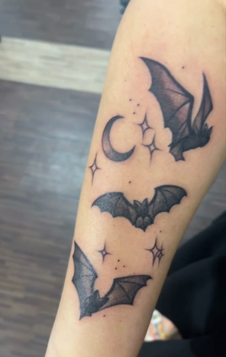 a person with a bat tattoo on their arm