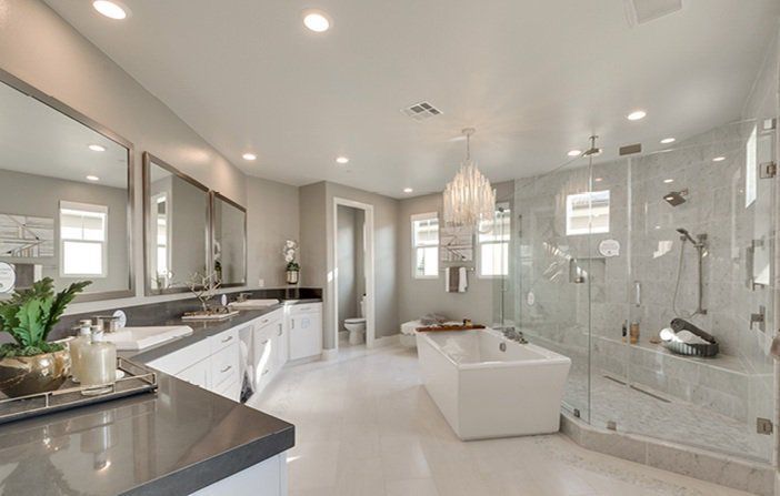 a large bathroom with two sinks and a walk in shower next to a bathtub