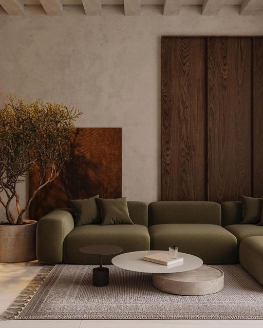 a living room filled with furniture and a tree in the corner on top of a rug