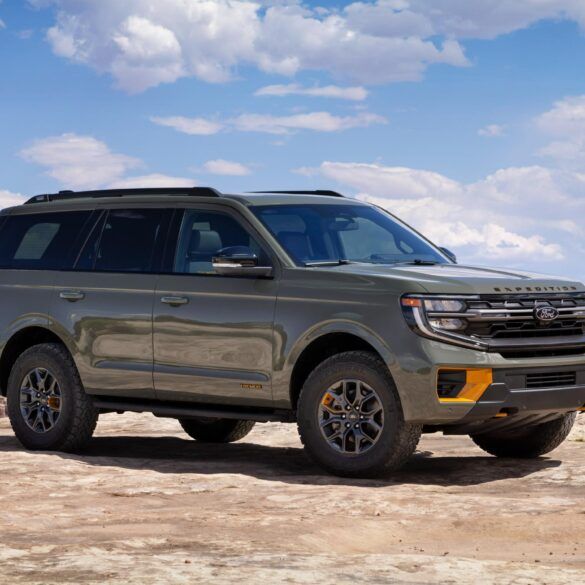 a silver ford expedition vehicle parked on the beach