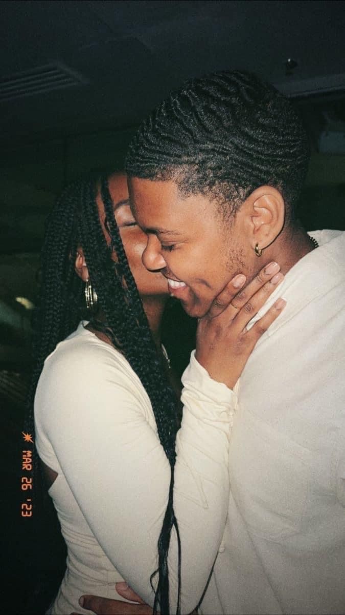 a man and woman hugging each other in the dark