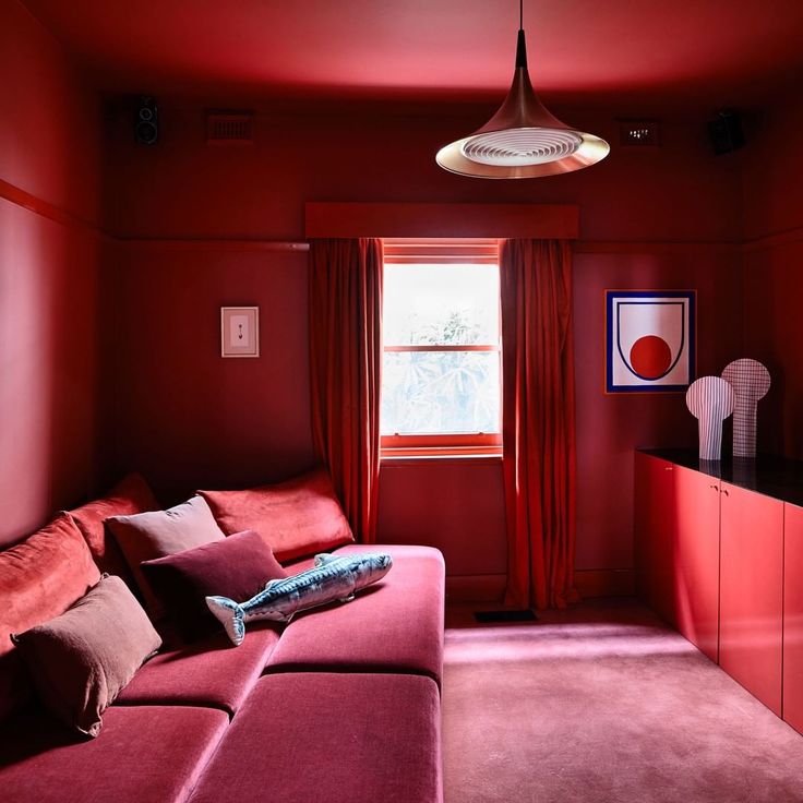 a living room filled with furniture and red walls