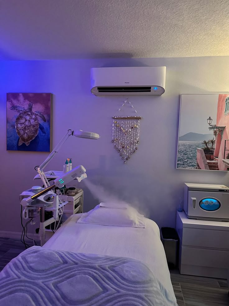 a room with a bed, air conditioner and pictures on the wall above it