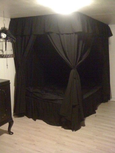 a room with a bed, dresser and birdcage