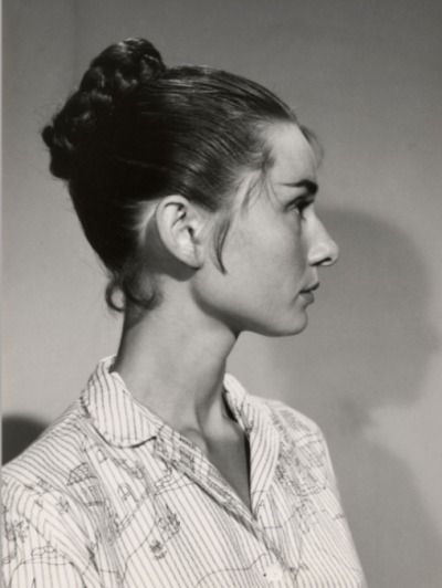 black and white photograph of a woman with her hair in a high bun hairstyle