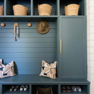 a blue bench with baskets and hats on it