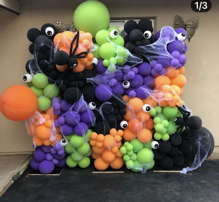 a bunch of balloons that are in the shape of animals with eyes and bats on them