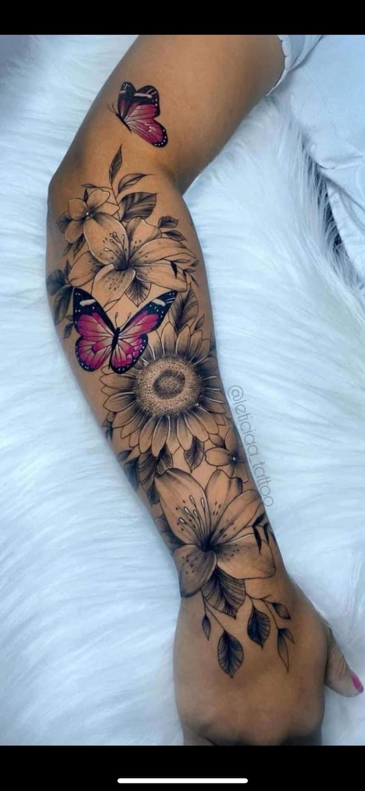 a woman's leg with flowers and butterflies on it