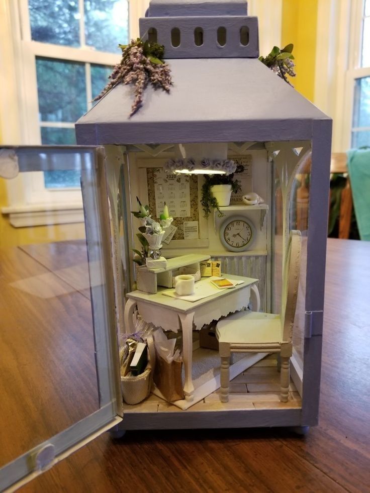 a doll house with furniture and accessories in it's display case on a wooden table