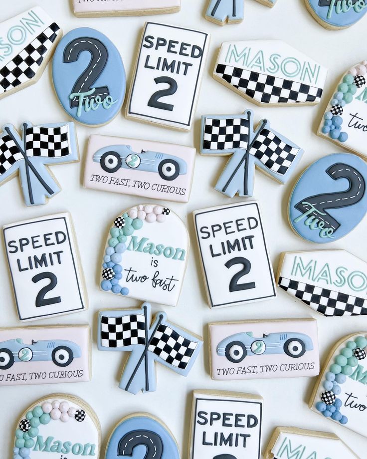 decorated cookies with race cars and numbers on them for a birthday or baby's first birthday