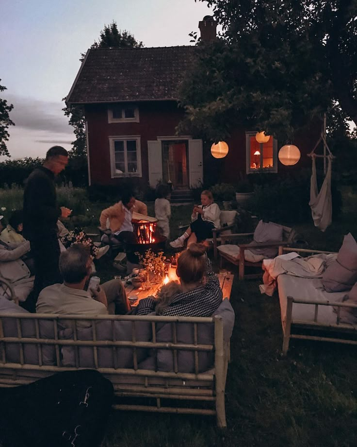 a group of people sitting around a fire pit