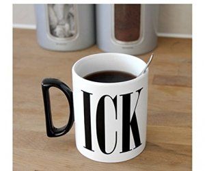 a black and white coffee mug sitting on top of a wooden table