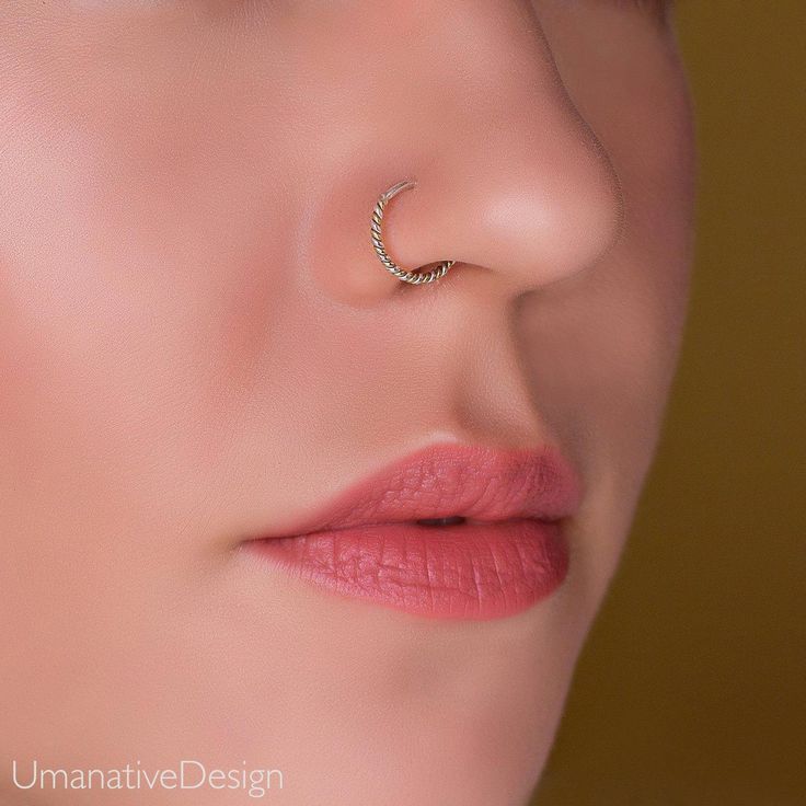 a woman's nose with a ring on it