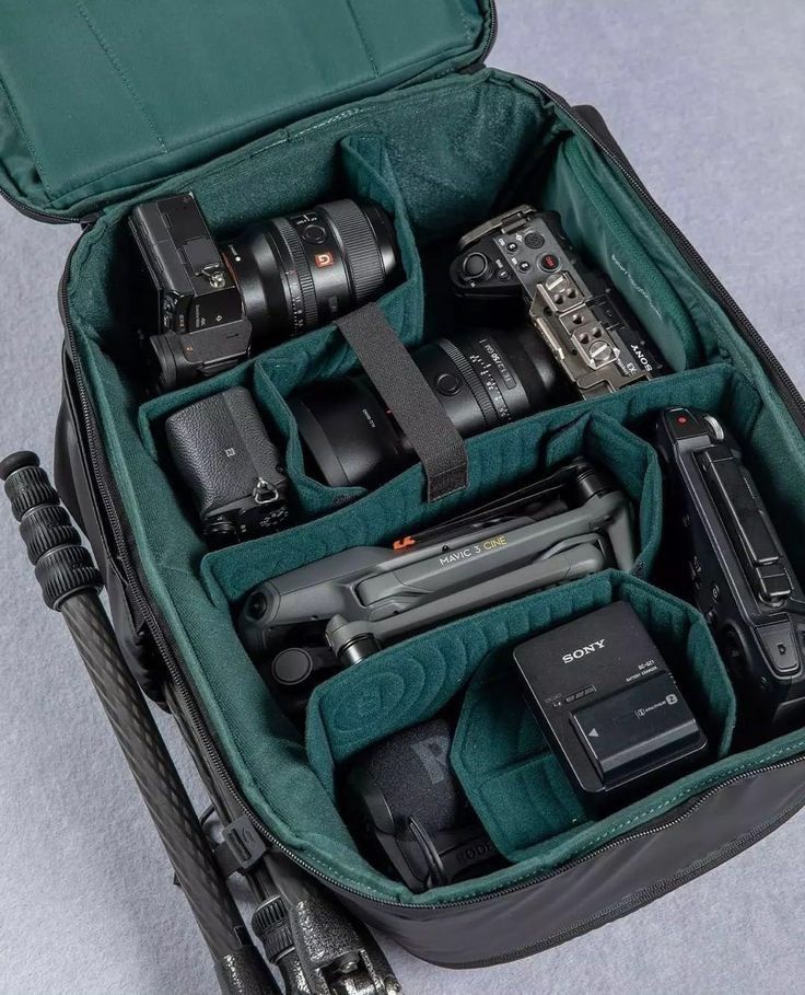 the contents of a camera bag are neatly packed