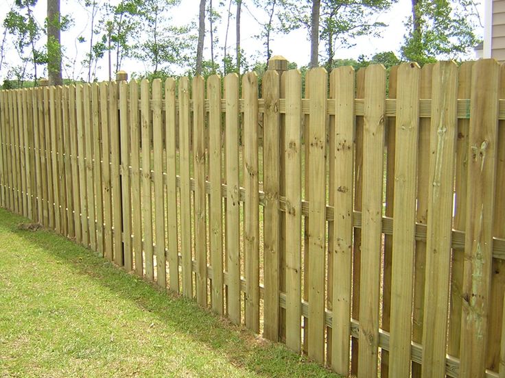 a wooden fence in front of a house