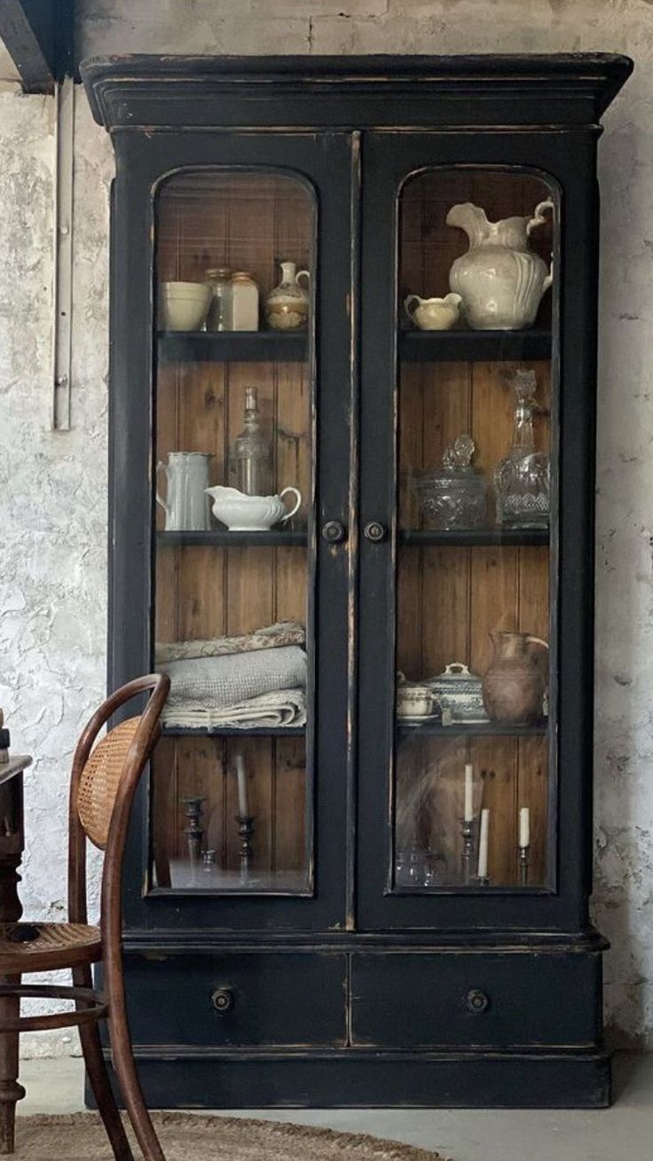 an old china cabinet with glass doors