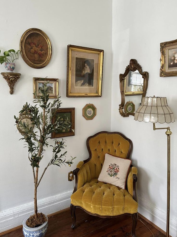 a living room filled with furniture and pictures on the wall next to a potted plant