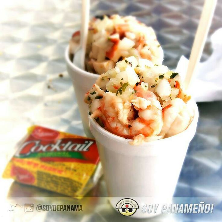 two cups filled with food sitting on top of a table