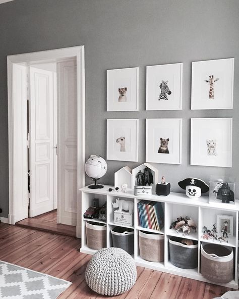 a living room filled with furniture and pictures on the wall