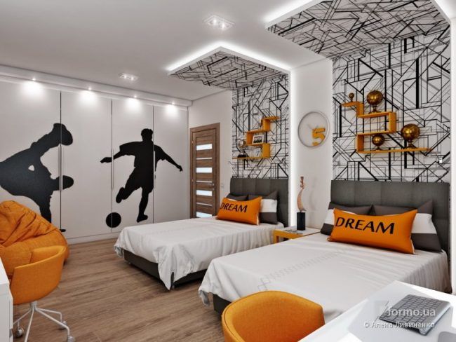 a bedroom with two beds, orange chairs and soccer themed wall decals on the walls