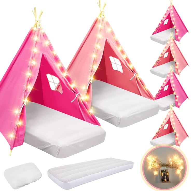 three pink tents with lights on them are next to a mattress and pillow set in the shape of a teepee