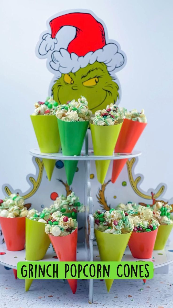 the grinch popcorn cones are stacked on top of each other